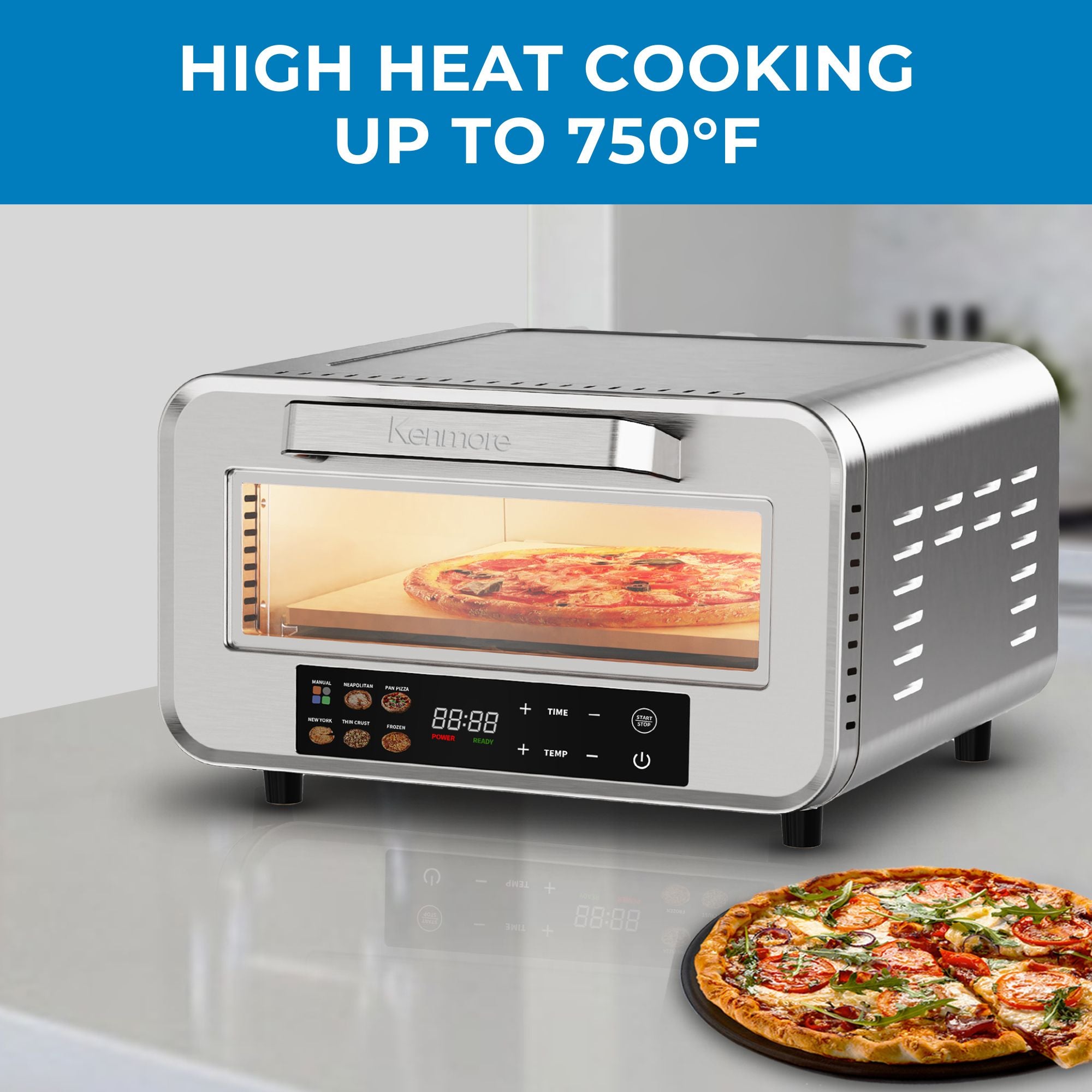 Kenmore portable countertop pizza oven with a pizza cooking inside and another beside it on a light gray counter. Text above reads, "High heat cooking up to 750°F"