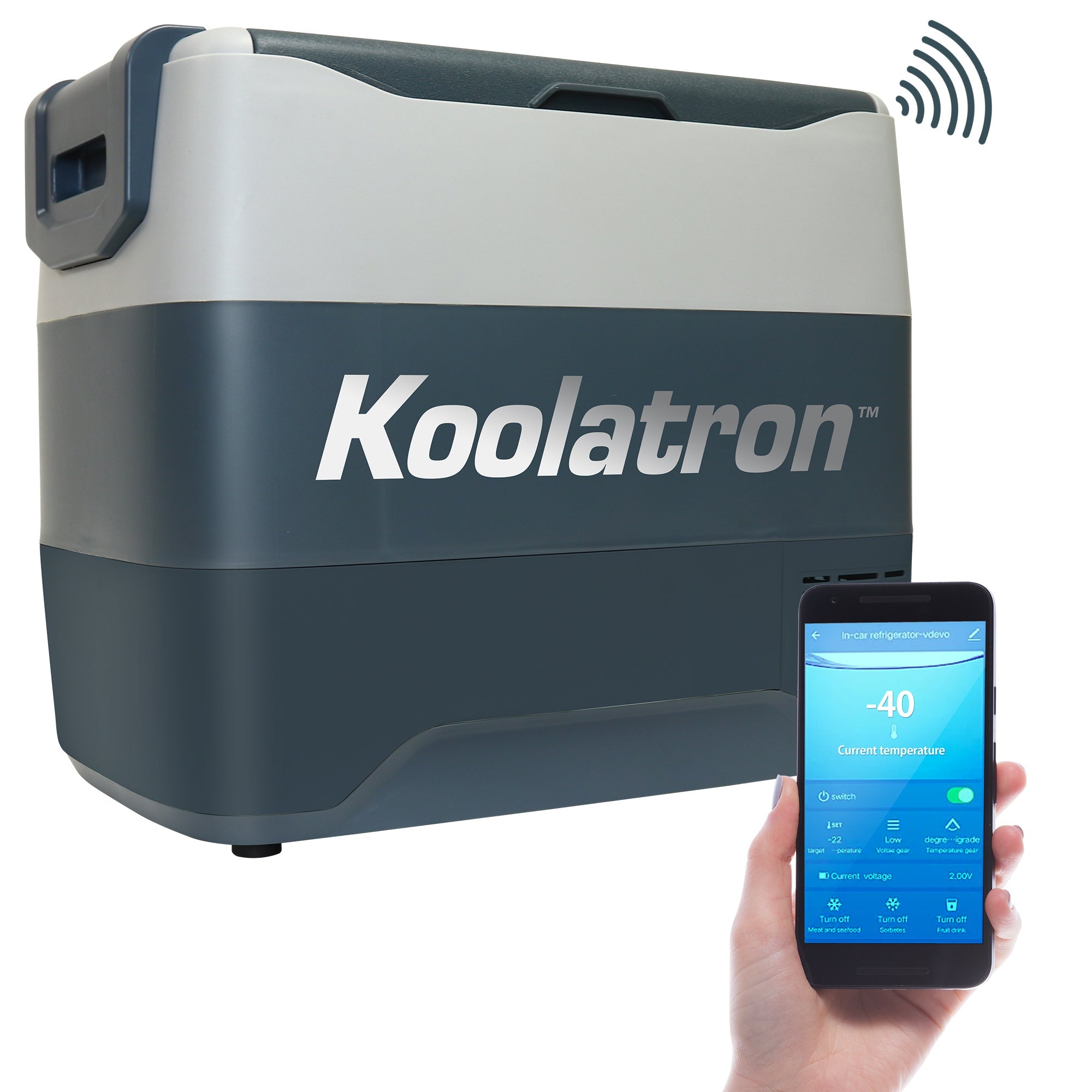Product shot of 12V travel fridge/freezer on a white background with a person's hand holding a smartphone with the Kool-atronSmart app on the screen in the foreground
